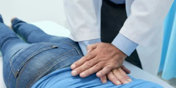 Chiropractor in Southwest Las Vegas performing spinal adjustment on patient to relieve back pain, neck pain, and headaches.